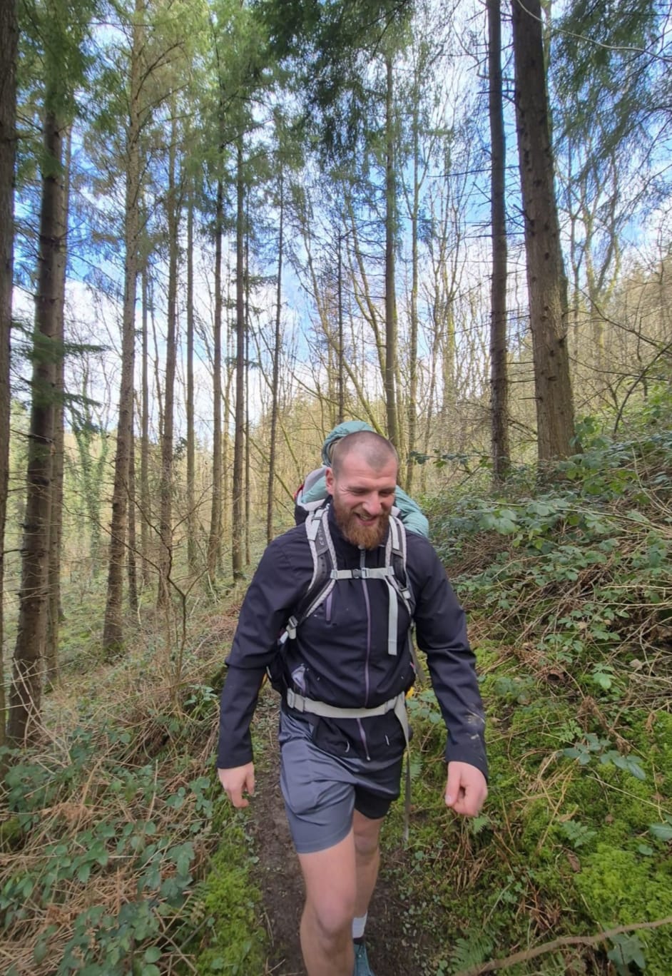 Toby on a wooded trail.